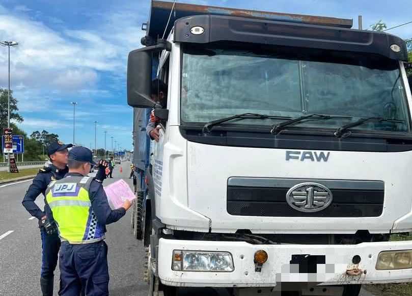 JPJ officer inspecting a commercial vehicle during SLD enforcement in Malaysia.